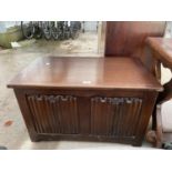 A REPRODUCTION OAK BLANKET CHEST WITH LINEN FOLD FRONT PANELS, 30" WIDE