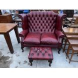 A RED LEATHER BUTTON-BACK WINGED TWO SEATER SETTEE ON CABRIOLE LEGS AND STOOL