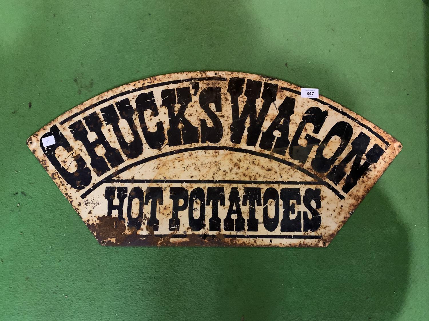 A VINTAGE METAL "CHUCK'S WAGON HOT POTATOES" SIGN