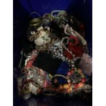 A LARGE BLUE CONTAINER OF MIXED COSTUME JEWELLERY TO INCLUDE NECKLACES, BANGLES, ETC