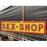AN ILLUMINATED 'SEX SHOP' SIGN