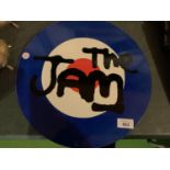 A METAL CIRCULAR "THE JAM" SIGN