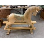 A VINTAGE WOODEN CARVED ROCKING HORSE - HEIGHT TO SADDLE 65CMS