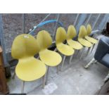 A SET OF SIX CALLIGNARIS CHAIRS WITH POLYCARBONATE ALL IN ONE SHAPED SEAT AND BACK ON WOODEN BASES
