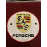 A CAST METAL "PORSCHE" CIRCULAR SIGN