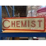 AN ILLUMINATED 'CHEMIST' SIGN