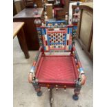 A MULTICOLOURED ASIAN LOW ELBOW CHAIR WITH TURNED LEGS AND BACK PANEL
