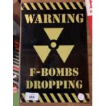 A METAL MAN CAVE SIGN 'F-BOMBS DROPPING'