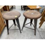 TWO CIRCULAR INDUSTRIAL STYLE STOOLS, STANDING ON POLISHED STEEL TAPERED LEGS