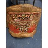 A LARGE LEATHER CAMEL SADDLE WITH WOVEN DETAIL