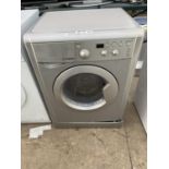 A SILVER INDESIT 7KG WASHING MACHINE BELIEVED IN WORKING ORDER BUT NO WARRANTY