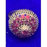 AN ORNATE 14 CARAT GOLD RING WITH TWENTY FIVE GARNETS SIZE K GROSS WEIGHT APPROXIMATELY 6.6 GRAMS