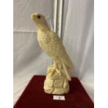 A RESIN FIGURE OF A BIRD OF PREY - HEIGHT 28CMS