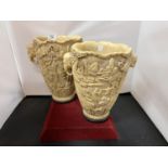 A PAIR OF LARGE ORNATE HEAVILY CARVED IVORINE VASES WITH ELEPHANT HEAD HANDLES