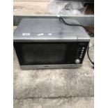 A SILVER DELONGHI MICROWAVE OVEN BELIEVED IN WORKINJG ORDER BUT NO WARRANTY