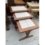 A NEST OF RETRO TEAK AND TILE INSET TABLES