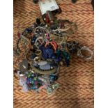 A CLEAR BOX OF MIXED COSTUME JEWELLERY TO INCLUDE NECKLACES, BANGLES ETC
