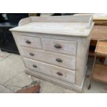 A VICTORIAN PINE GALLERY BACK CHEST OF TWO SHORT AND TWO LONG DRAWERS WITH LIMED FINISH