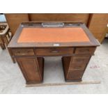 A CHILD'S MINIATURE TWIN PEDESTAL EXECUTIVE DESK WITH ONE DOOR, SIX DRAWERS AND LEATHER WRITING