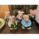 A FAMILY OF FIVE NAT WEST PIG MONEY BOXES