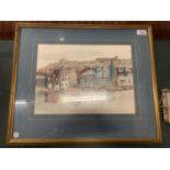 A FRAMED WATERCOLOUR OF A HARBOUR FRONT AND SURROUNDINGS SIGNED MARGARET PARKER 1984