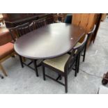 A STAG MINSTREL EXTENDING DINING TABLE AND FOUR CHAIRS