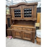 A MODERN OAK DRESSER WITH CUPBOARDS AND DRAWERS TO THE BASE AND GLAZED DOOR TO THE UPPER PORTION,