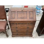 AN OAK REPRODUCTION LINEN FOLD BUREAU, 29.5" WIDE