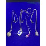 FOUR SILVER NECKLACES MARKED 925 WITH VARIOUS PENDANTS TO INCLUDE CLEAR STONES