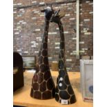 A PAIR OF WOODEN ORNAMENTAL GIRAFFES' HEADS HEIGHTS APPROXIMATELY 68CM AND 70CM