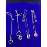 FOUR SILVER NECKLACES WITH PENDANTS