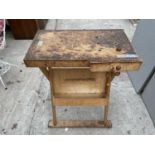 A SMALL WOODEN WORK BENCH WITH WOODEN VICE
