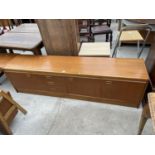 A RETRO JENTIQUE TEAK SIDEBAORD ENCLOSING THREE DRAWERS AND THREE CUPBOARDS