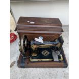 A VINTAGE SINGER SEWING MACHINE IN A WOODEN CASE