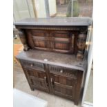 A SMALL PRIORY OAK COURT CUPBOARD WITH TWO LOWER DOORS AND DRAWERS AND AN UPPER DOOR