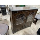 A PRIORY STYLE GLAZED AND LEADED BOOKCASE WITH CUPBOARDTO THE BASE, 41" WIDE