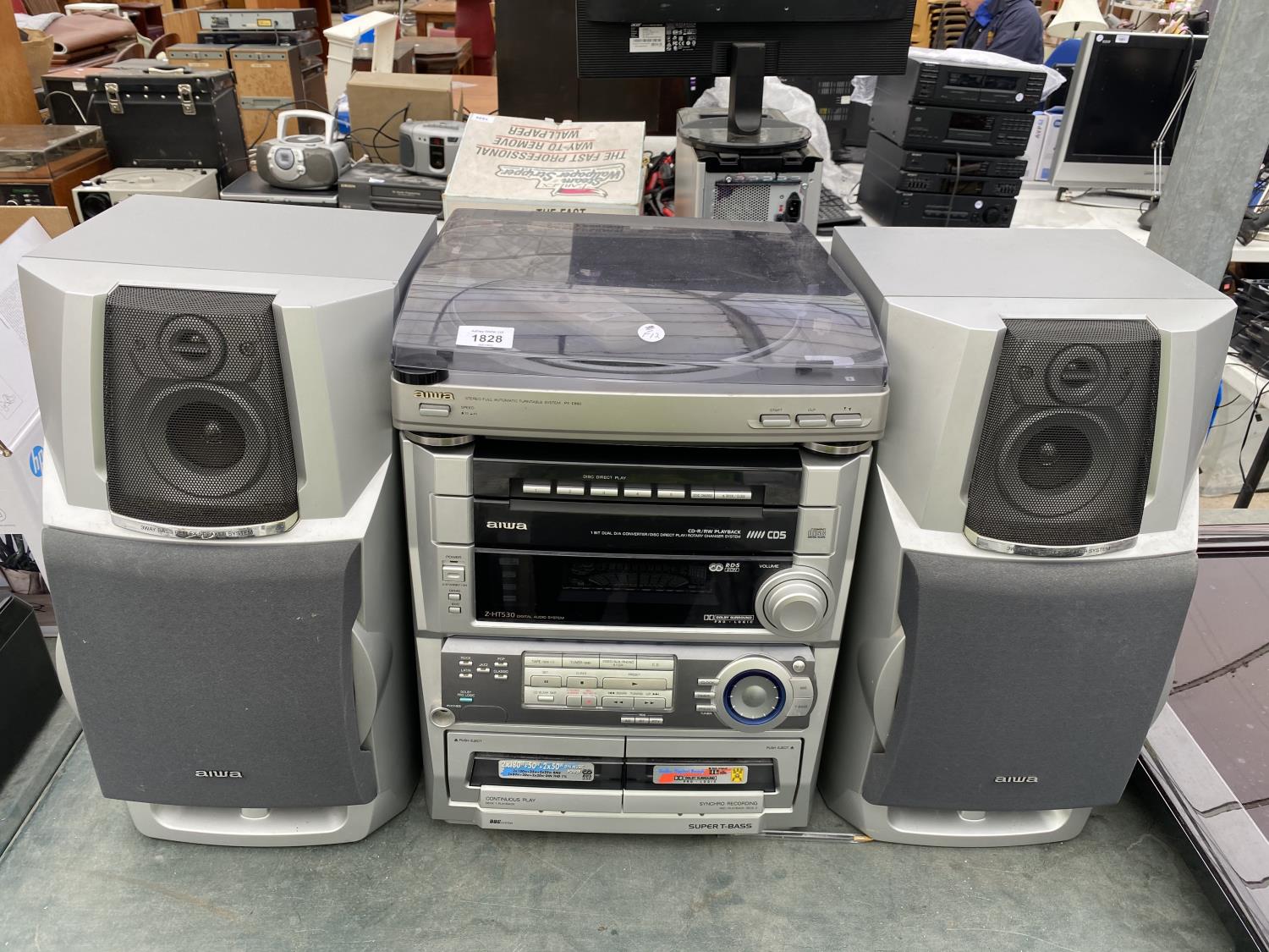 AN AIWA STEREO SYSTEM WITH TWO SPEAKERS IN W/O BUT NO WARRENTY