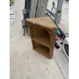 A SMALL WOODEN CORNER SHELVING CABINET