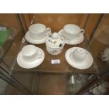 FOUR VILLEROY AND BOCH CUPS AND SAUCERS AND A HONEY POT OF THE SAME
