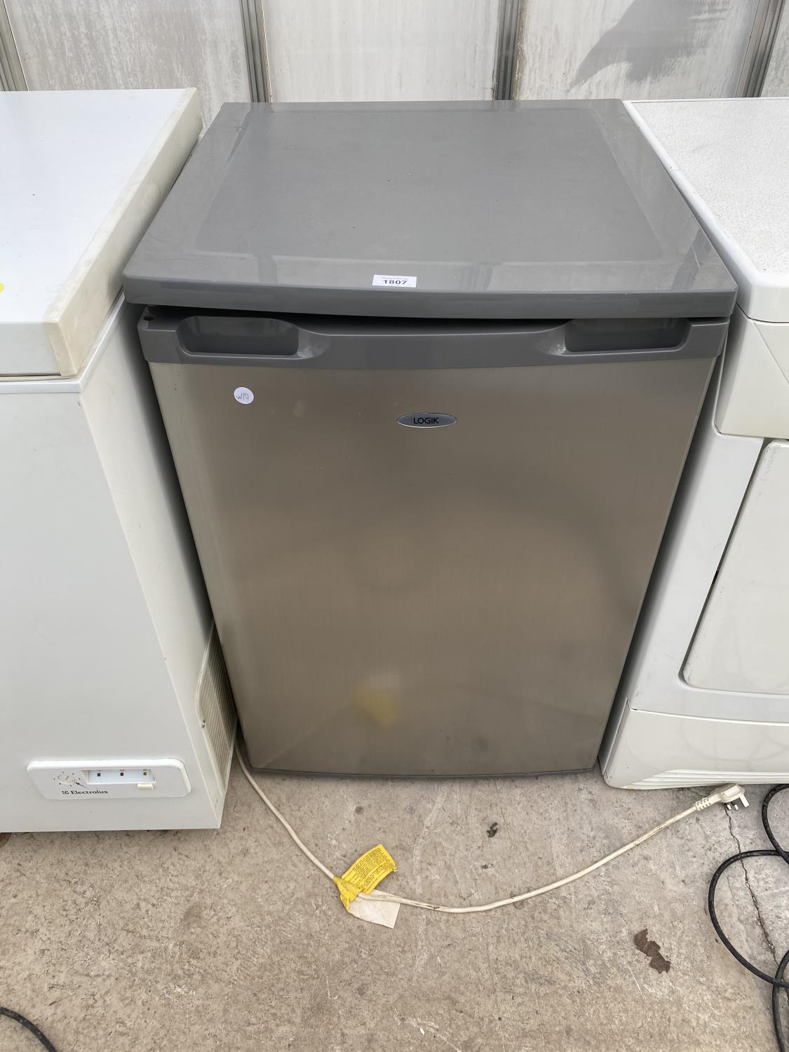 A GREY UNDERCOUNTER LOGIK FRIDGE IN W/O BUT NO WARRENTY