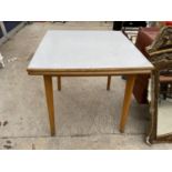 A FORMICA TOPPED KITCHEN TABLE