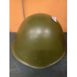 A GREEN PAINTED STEEL HELMET AND LINER