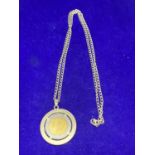 A SILVER NECKLACE MARKED 925 WITH A COIN IN A MOUNT