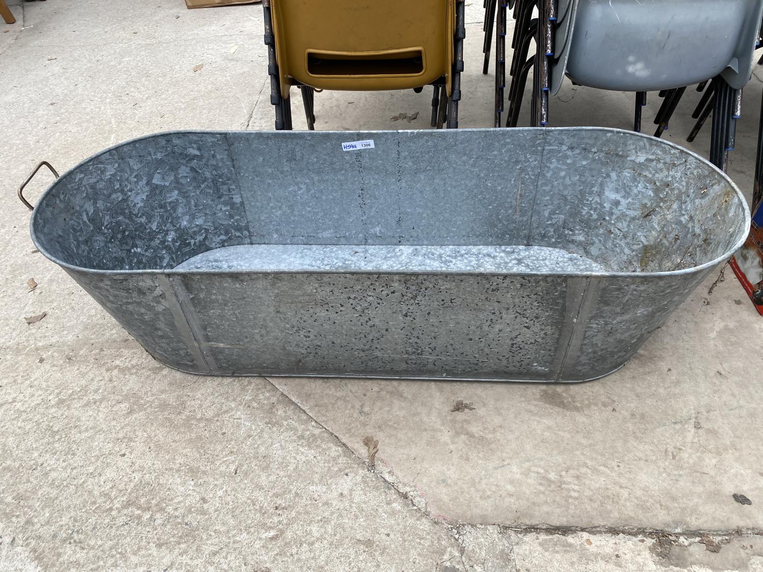 A LARGE STAINLESS STELL BATH TUB