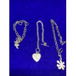 THREE SILVER BRACELETS TO INCLUDE A FAIRY, TEDDY HEART AND FLOWER DESIGN