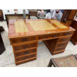 A YEW WOOD TWIN PEDESTAL DESK WITH NINE DRAWERS AND THREE SECTION LEATHER WRITING SURFACE - LEFT