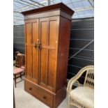 AN OAK WARDROBE WITH TWO DOORS, EBONY AND BRASS HANDLES AND BRASS COAT PEGS