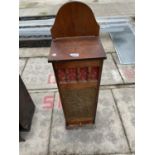 A CONTINTENTAL FRENCH BREAD STICK CABINET WITH EMBOSSED BRASS DOOR