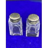 A PAIR OF MINATURE SILVER TOPPED GLASS CRUETS