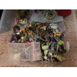 A LARGE CLEAR CONTAINER OF MIXED COSTUME JEWELLERY TO INCLUDE BANGLES, BRACELETS, NECKLACES ETC